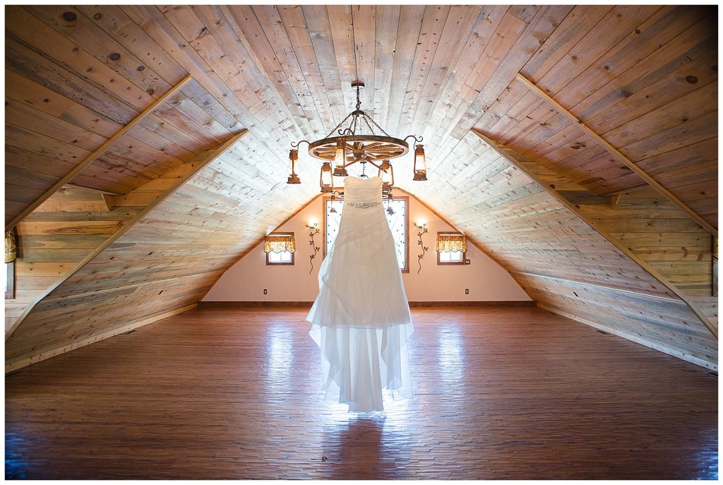 Wedding dress hanging from chandelier
